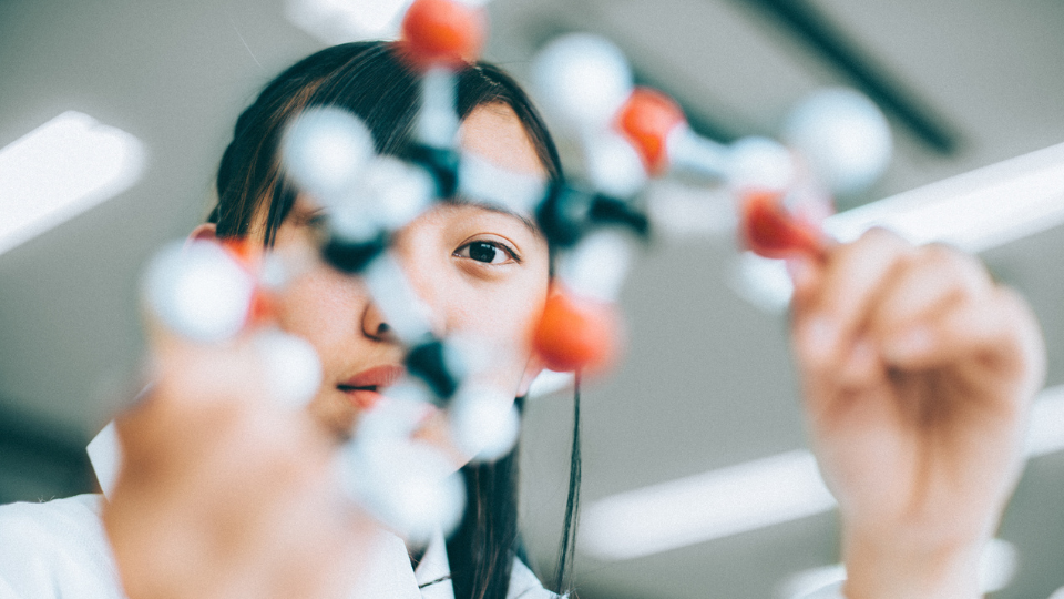 Woman with molecule in lab