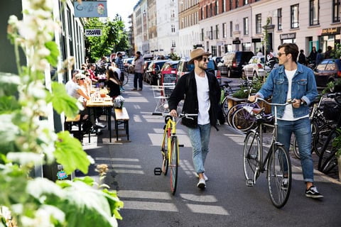 Friends walking with bikes by Ty Stange 